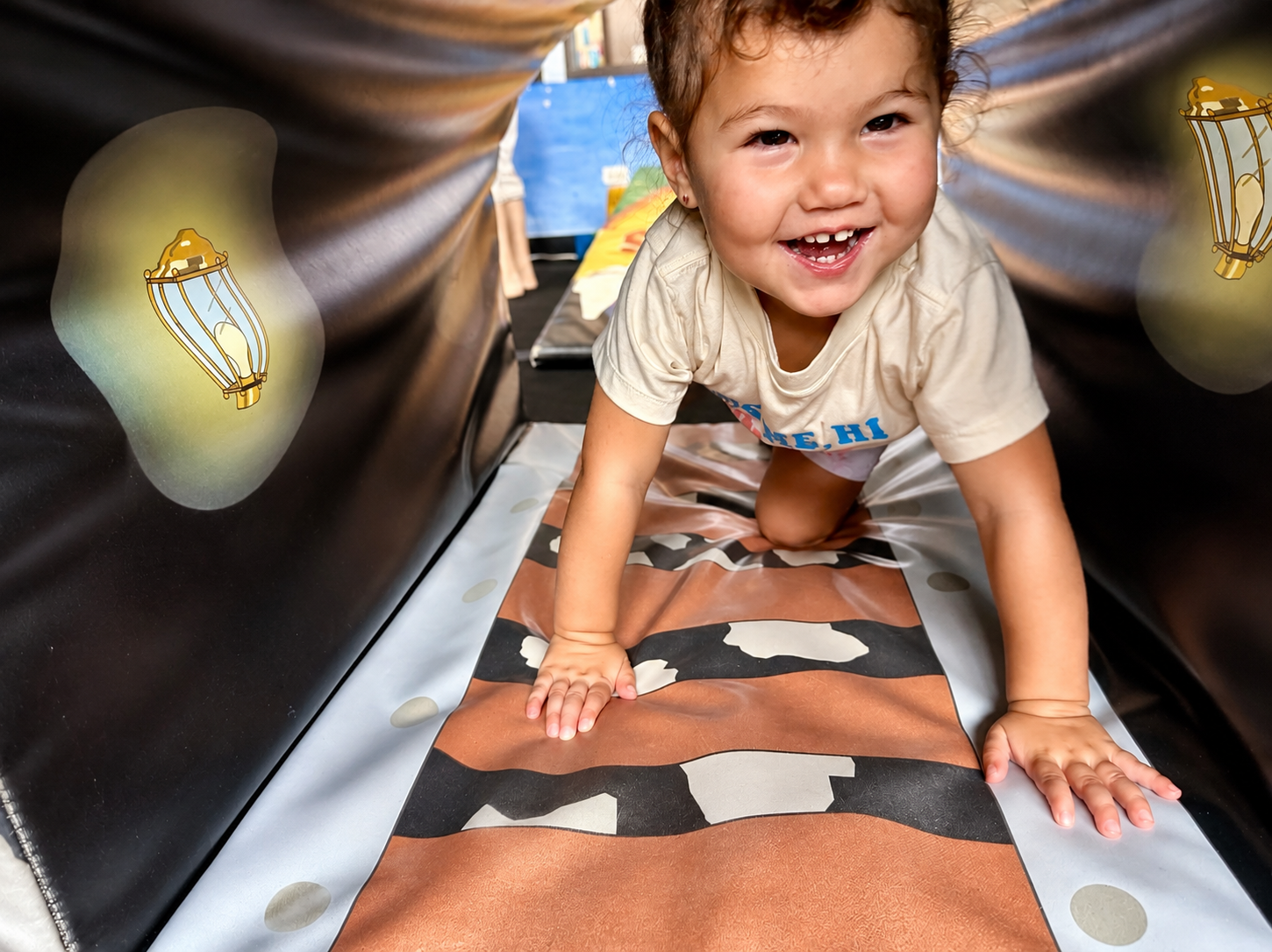 Toddler crawling through tunnel at Huntley Unlimited Gymnastics tots gym