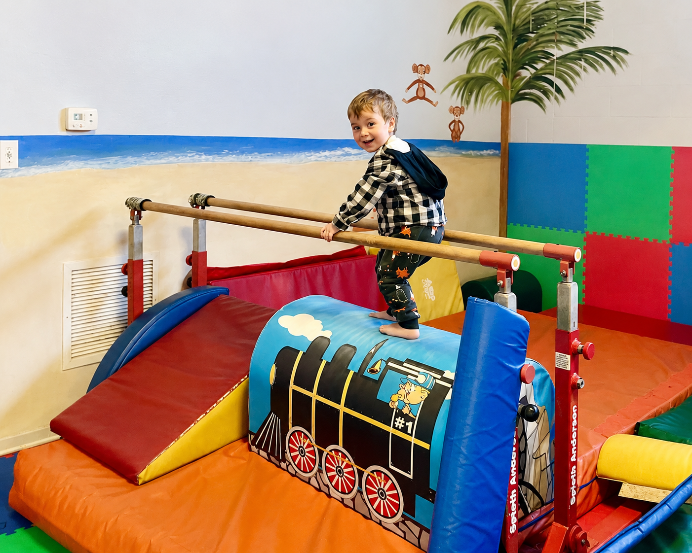 Young boy balancing on equipment in the tots gym